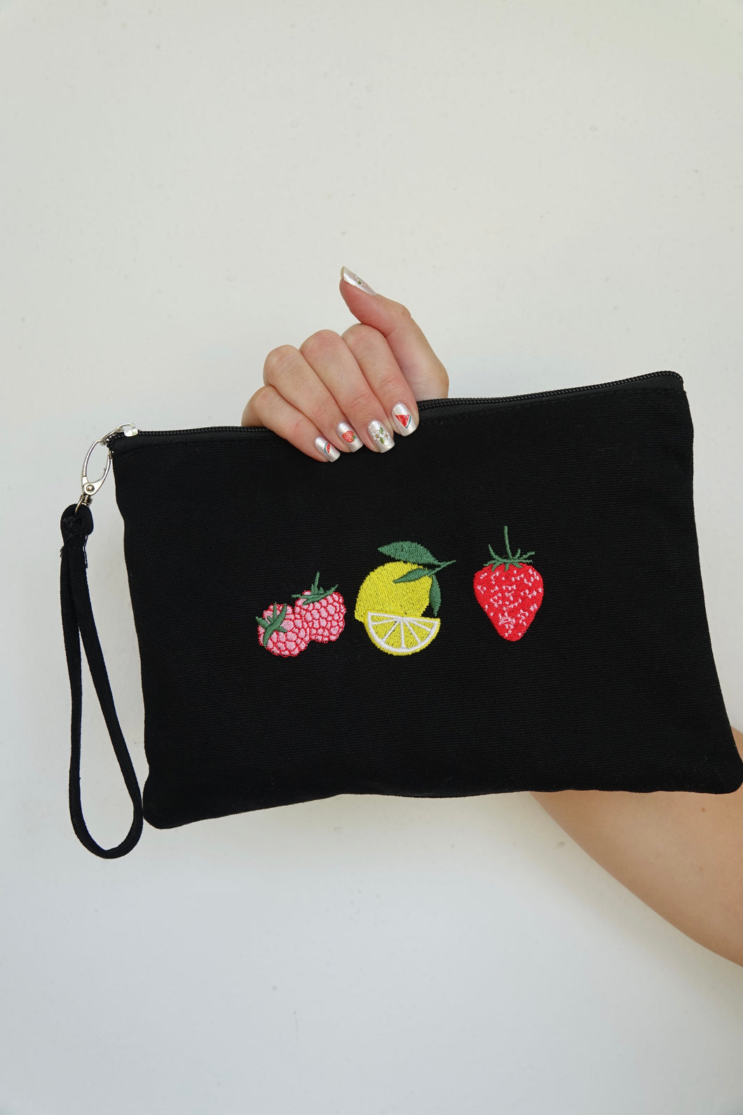 Canvas clutch bag in black with trio fruit embroidery