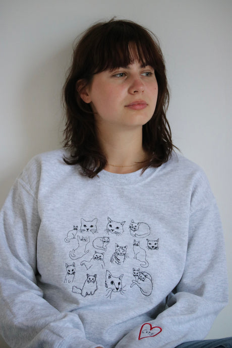 Cat doodle embroidered sweater with heart cat sleeve detail