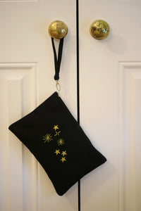 Canvas clutch bag in black with metallic constellation embroidery