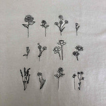 Load image into Gallery viewer, Floral embroidered organic t-shirt design