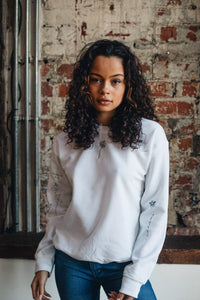 Embroidered tattoo style sweater with sleeve details