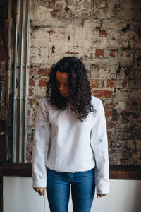 Embroidered tattoo style sweater with sleeve details