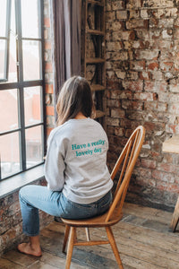Embroidered have a really lovely day back sweater with reminder sleeve