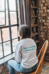 Embroidered have a really lovely day back sweater with reminder sleeve